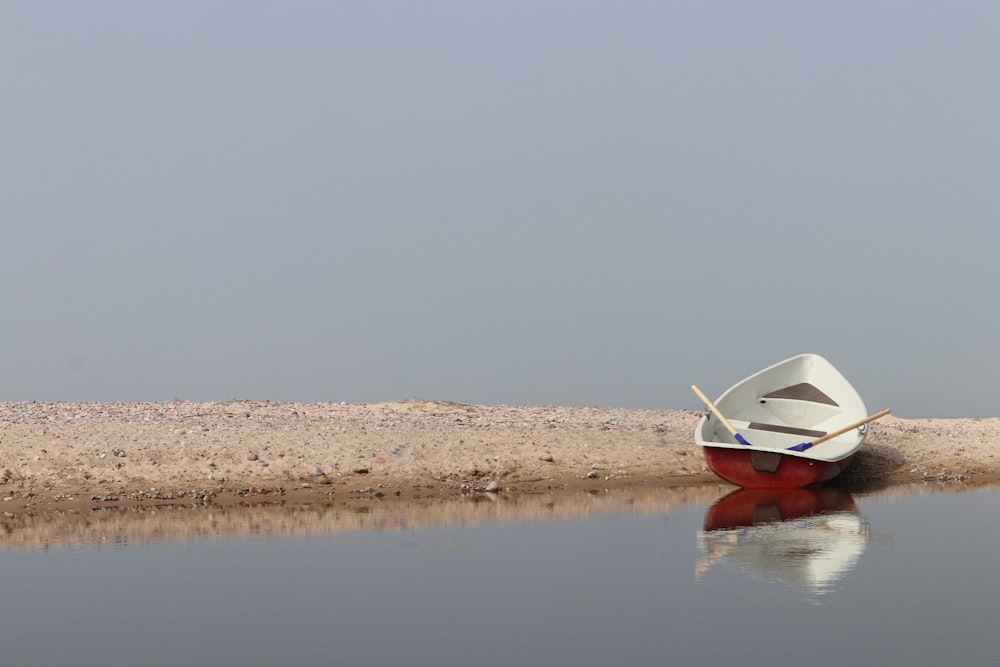 a small boat sitting on top of a body of water