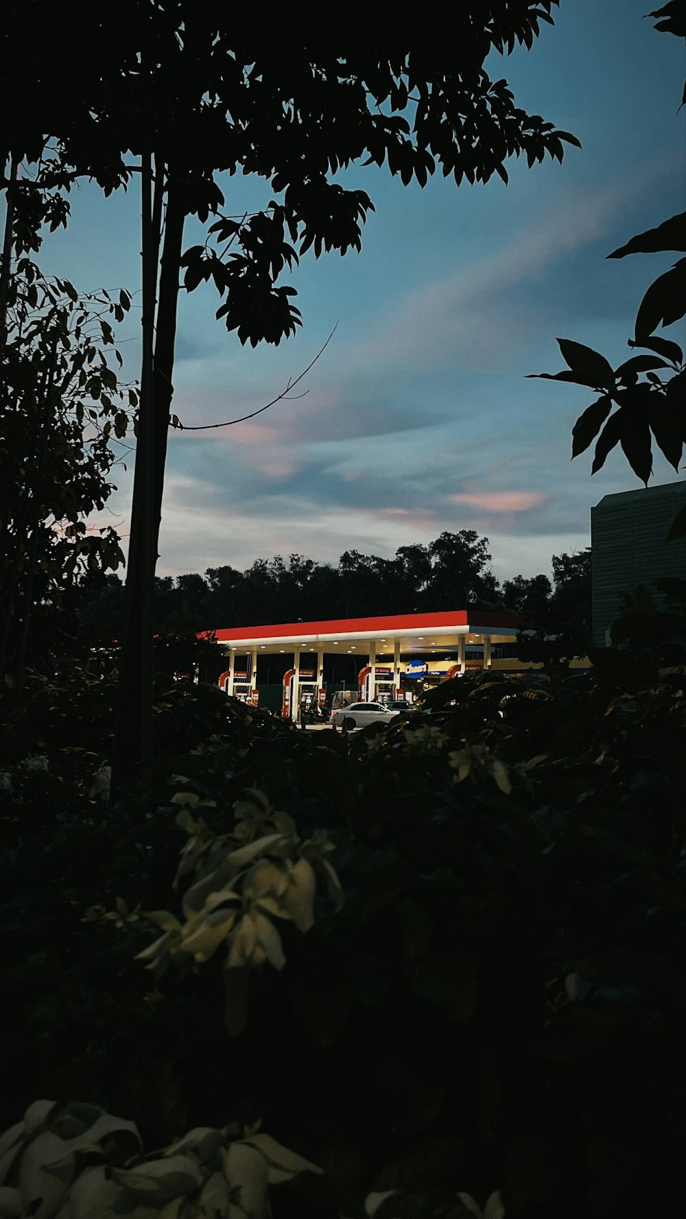 a gas station is lit up at night