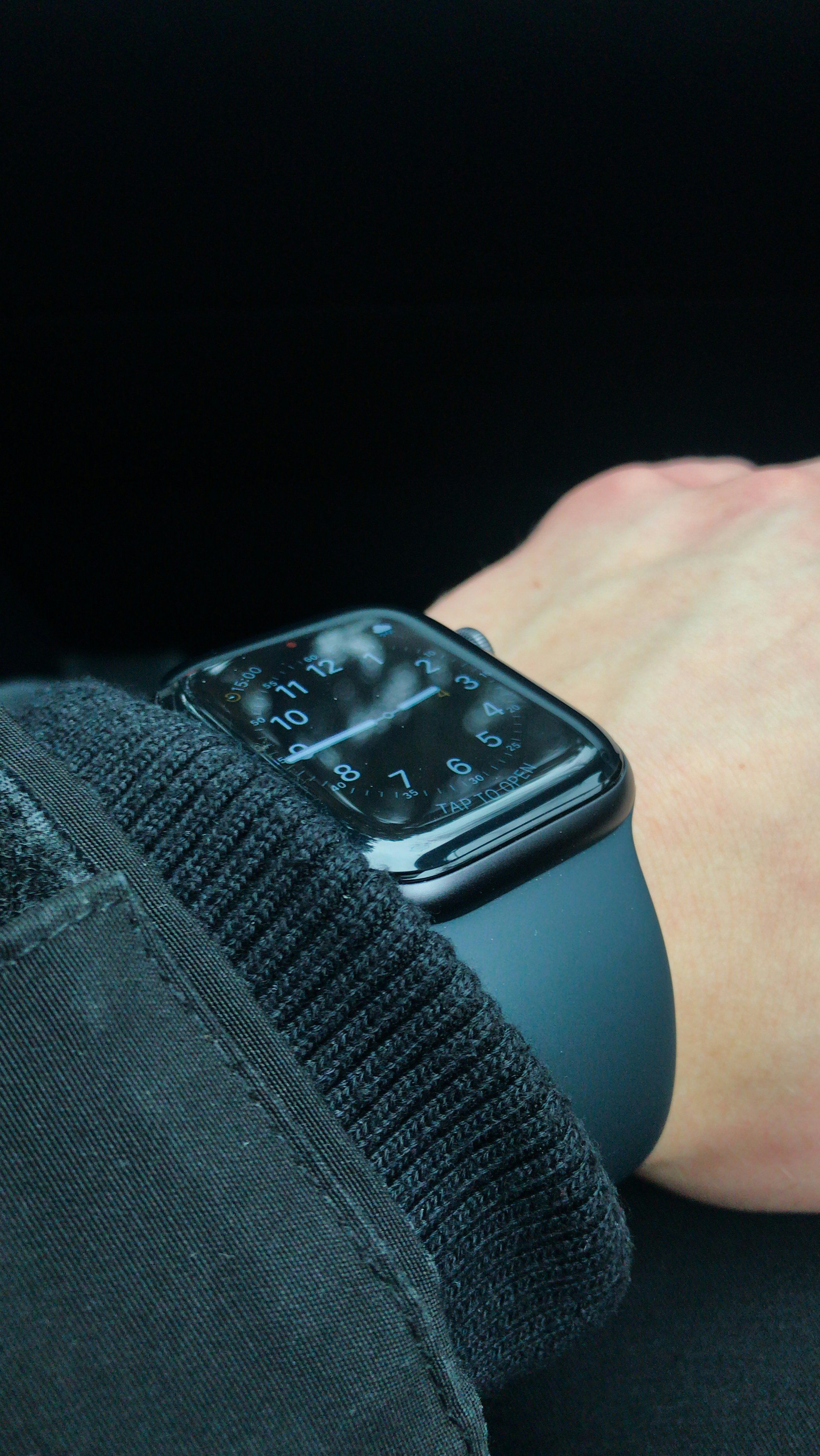 a person's hand holding an apple watch