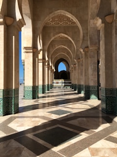 a long hallway with arches and tiled floors