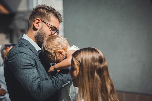 a man in a suit holding a small child