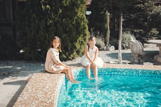 Family relaxing by a clean backyard pool after dependable pool service in Central Texas.