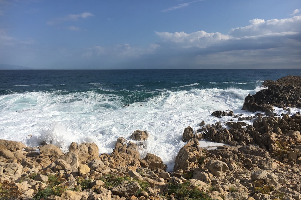 a view of the ocean from a rocky shore