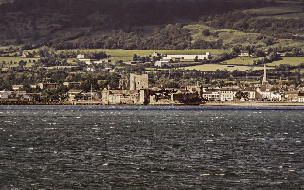 a large body of water with a city in the background