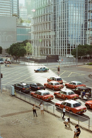 A busy street in Stockholm with taxis and pedestrians.