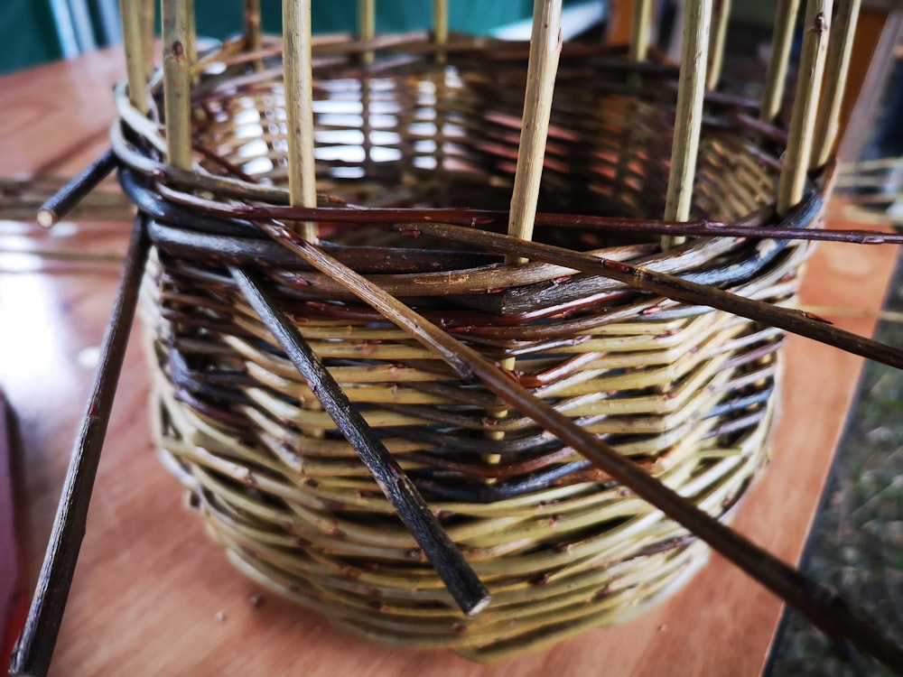 a wicker basket with sticks sticking out of it
