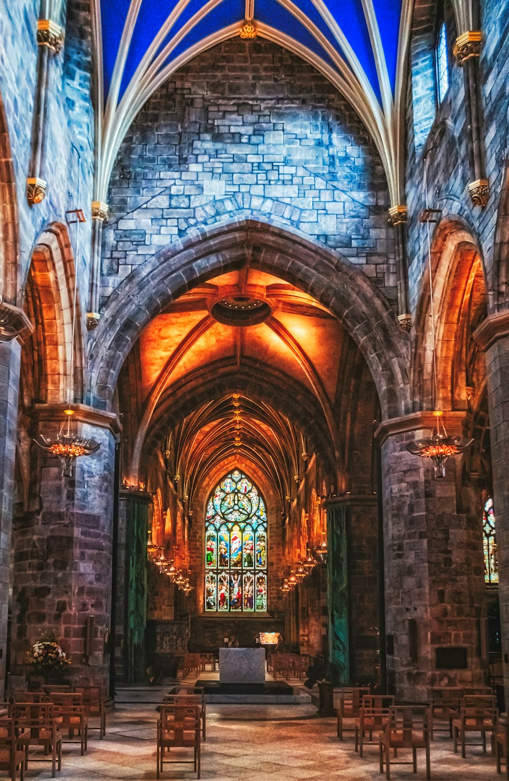 a large cathedral with stained glass windows and pews