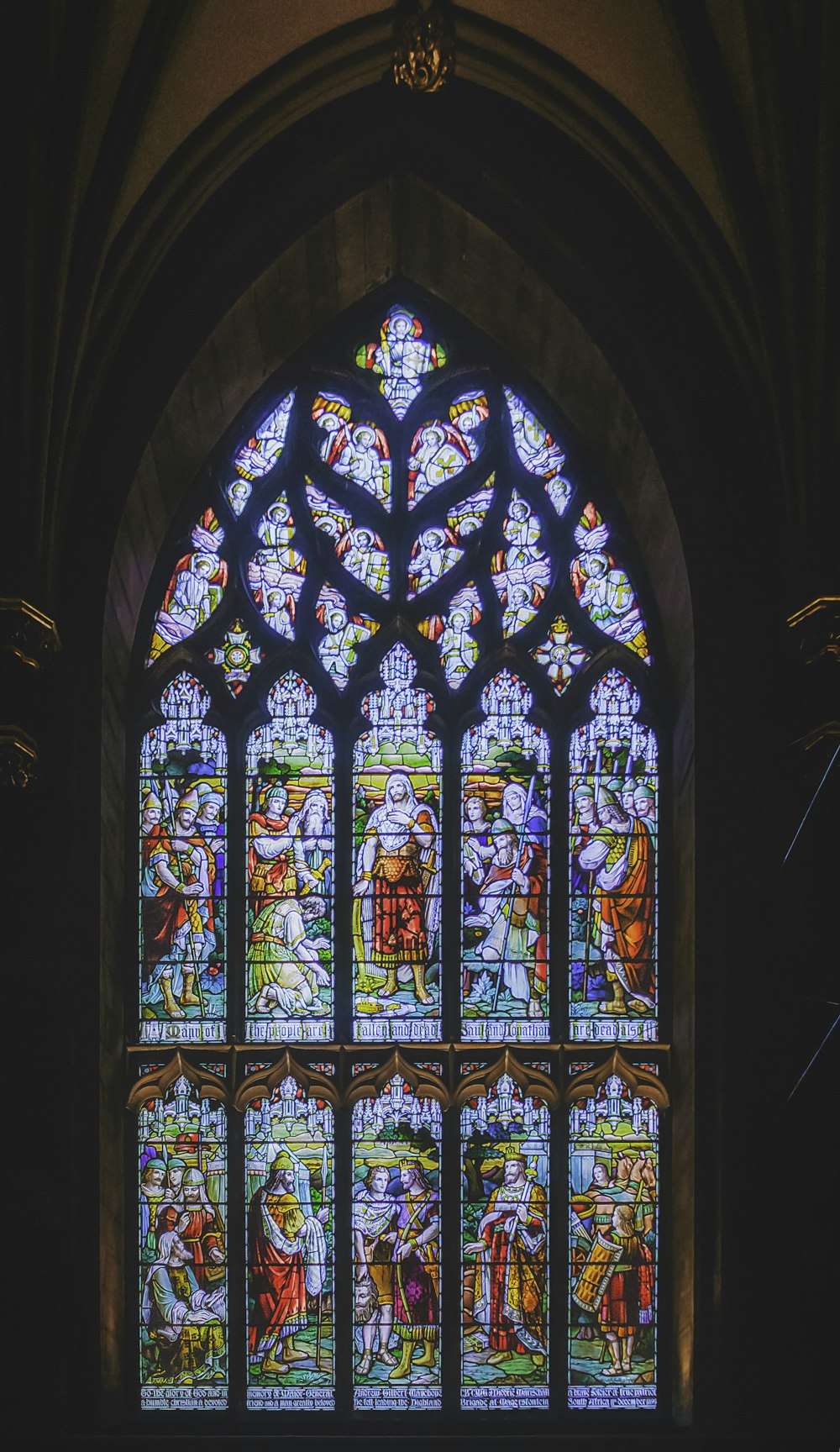 a large stained glass window inside of a church