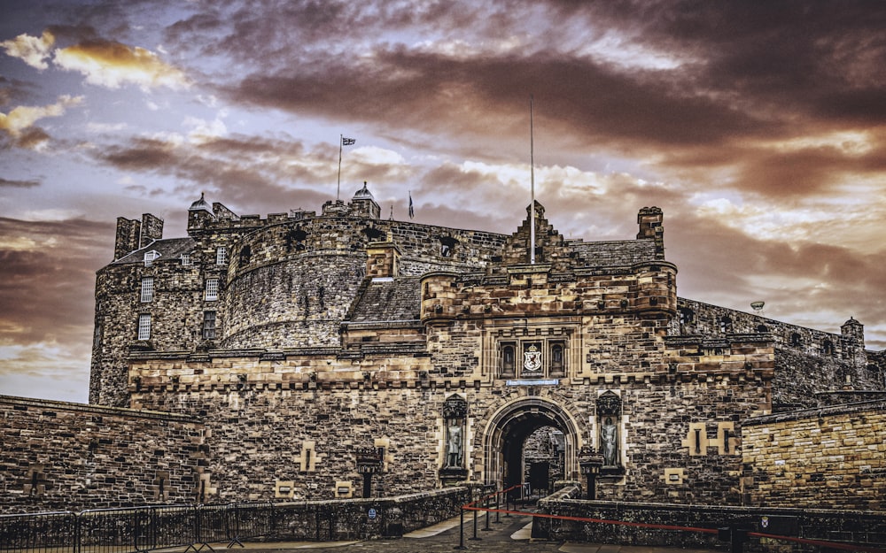 a castle with a gate and a flag on top of it