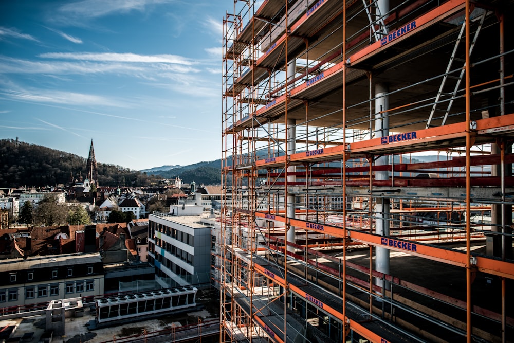 a building with scaffolding around it and a clock tower in the background