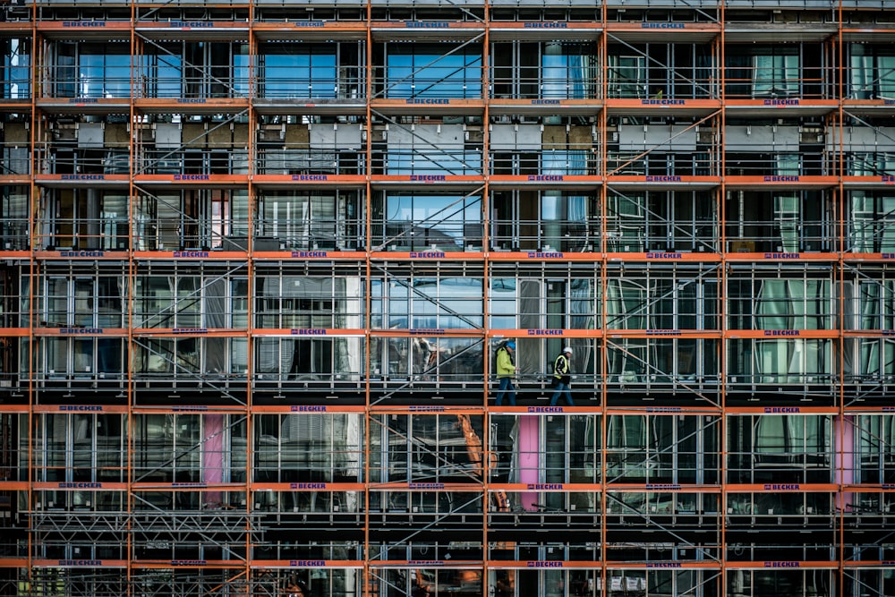 a man standing on a scaffolding in front of a building