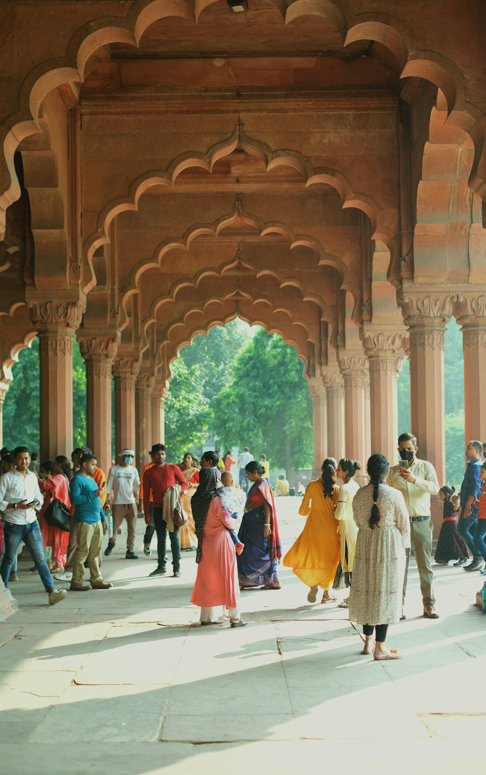 a group of people standing under a wooden structure