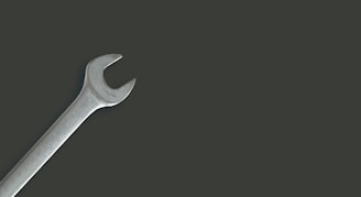a wrench on a black background with a shadow