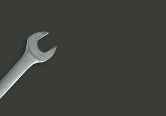 a wrench on a black background with a shadow