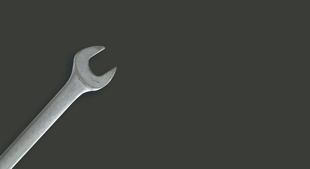 a wrench on a black background with a shadow