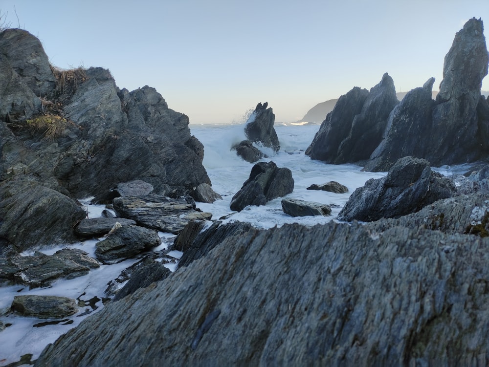 a group of rocks sitting on top of a beach