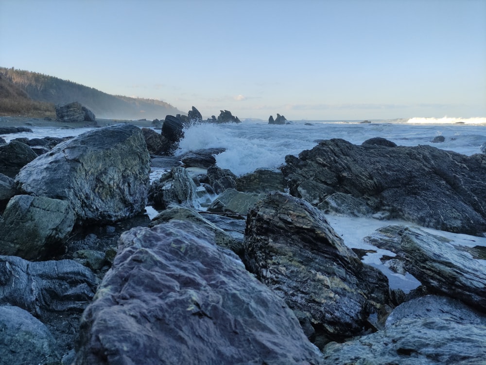 a bunch of rocks that are by the water