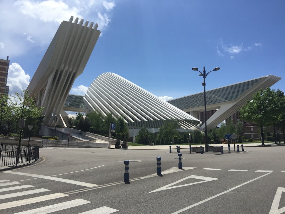 a large white building sitting on the side of a road