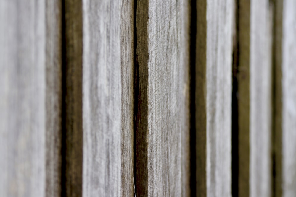 a close up of a wooden fence with vertical slats