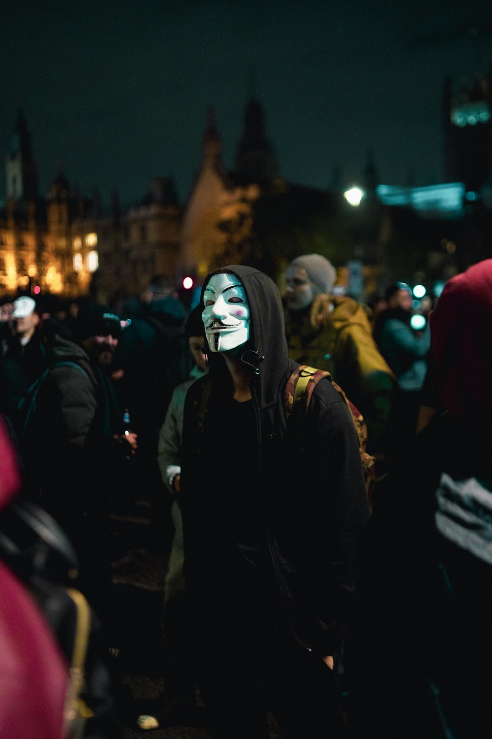 a person with a painted face standing in a crowd