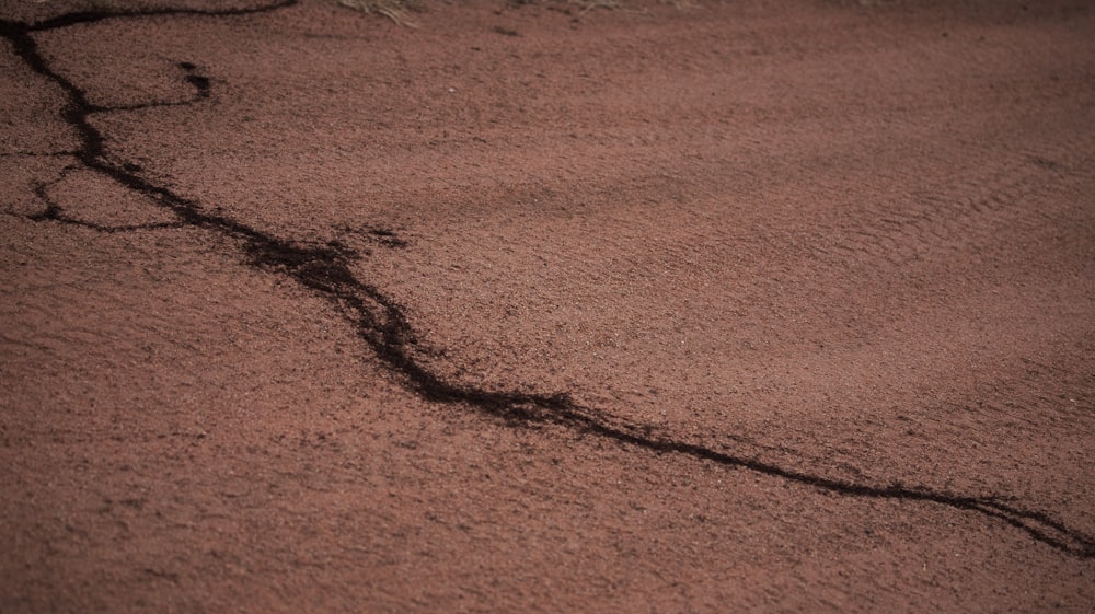 a crack in the ground in the sand