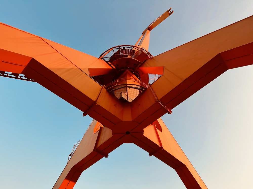 a large orange structure with a clock on top of it