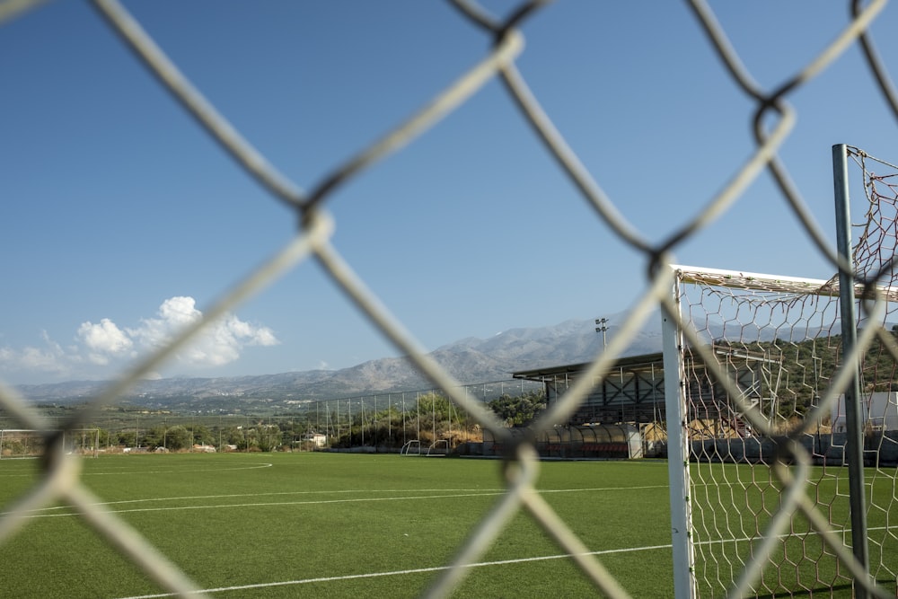a view of a soccer field through a fence