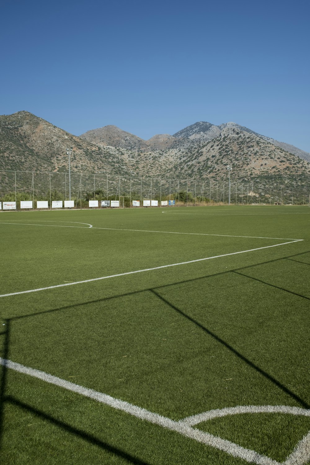 a soccer field with mountains in the background