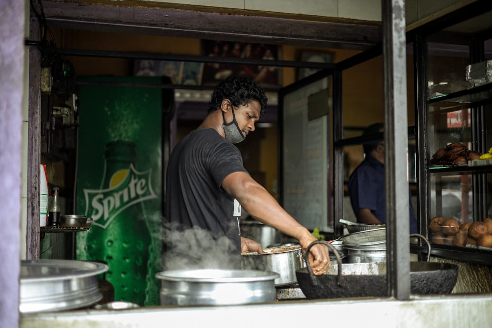 a man wearing a face mask cooking in a kitchen