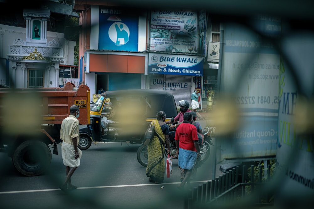 a group of people walking across a street