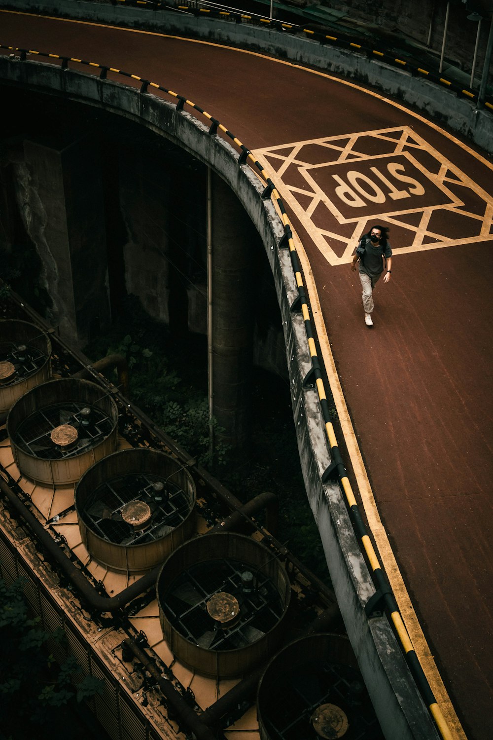 a person walking across a bridge over a river