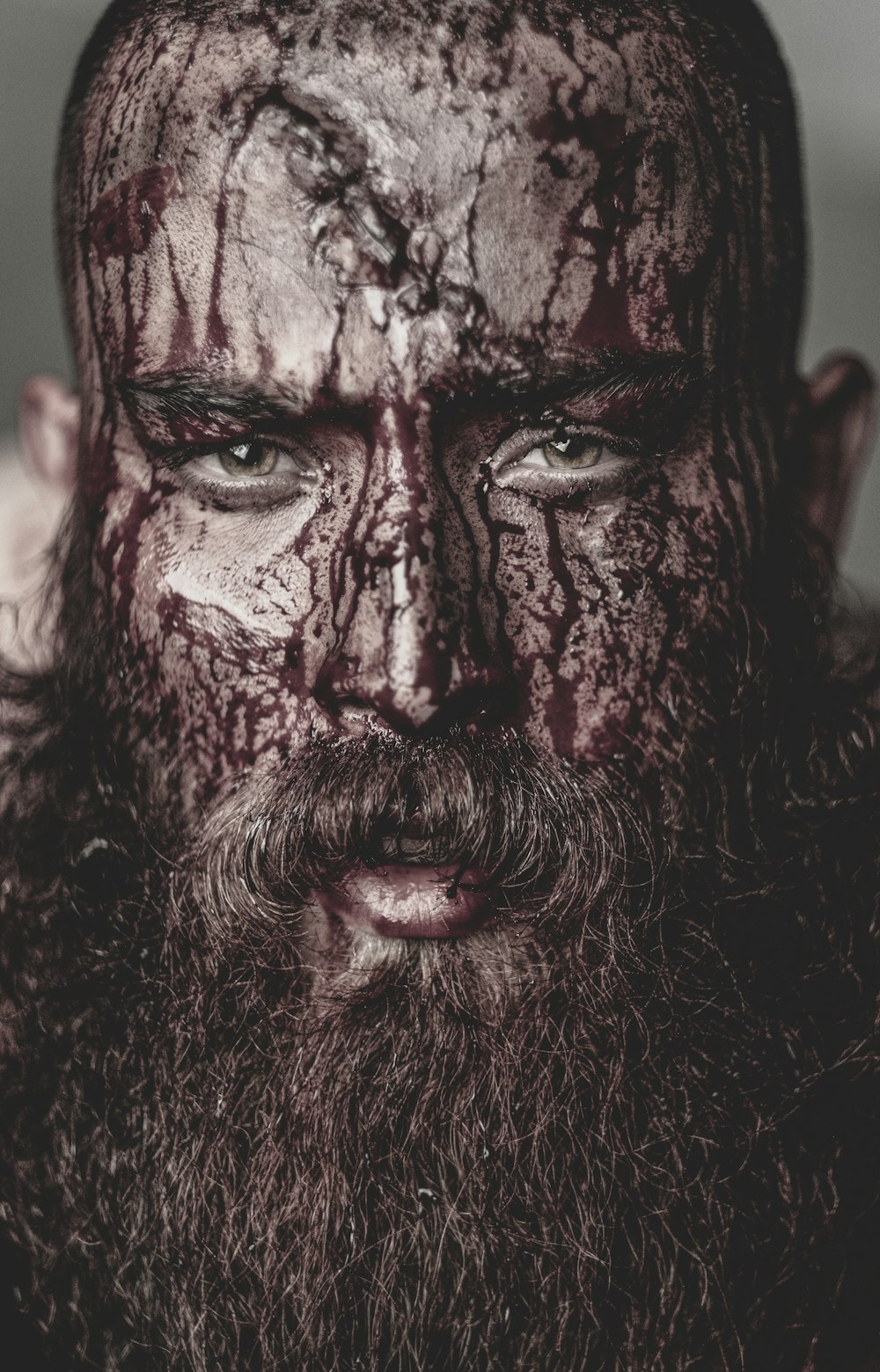 a close up of a man with blood on his face