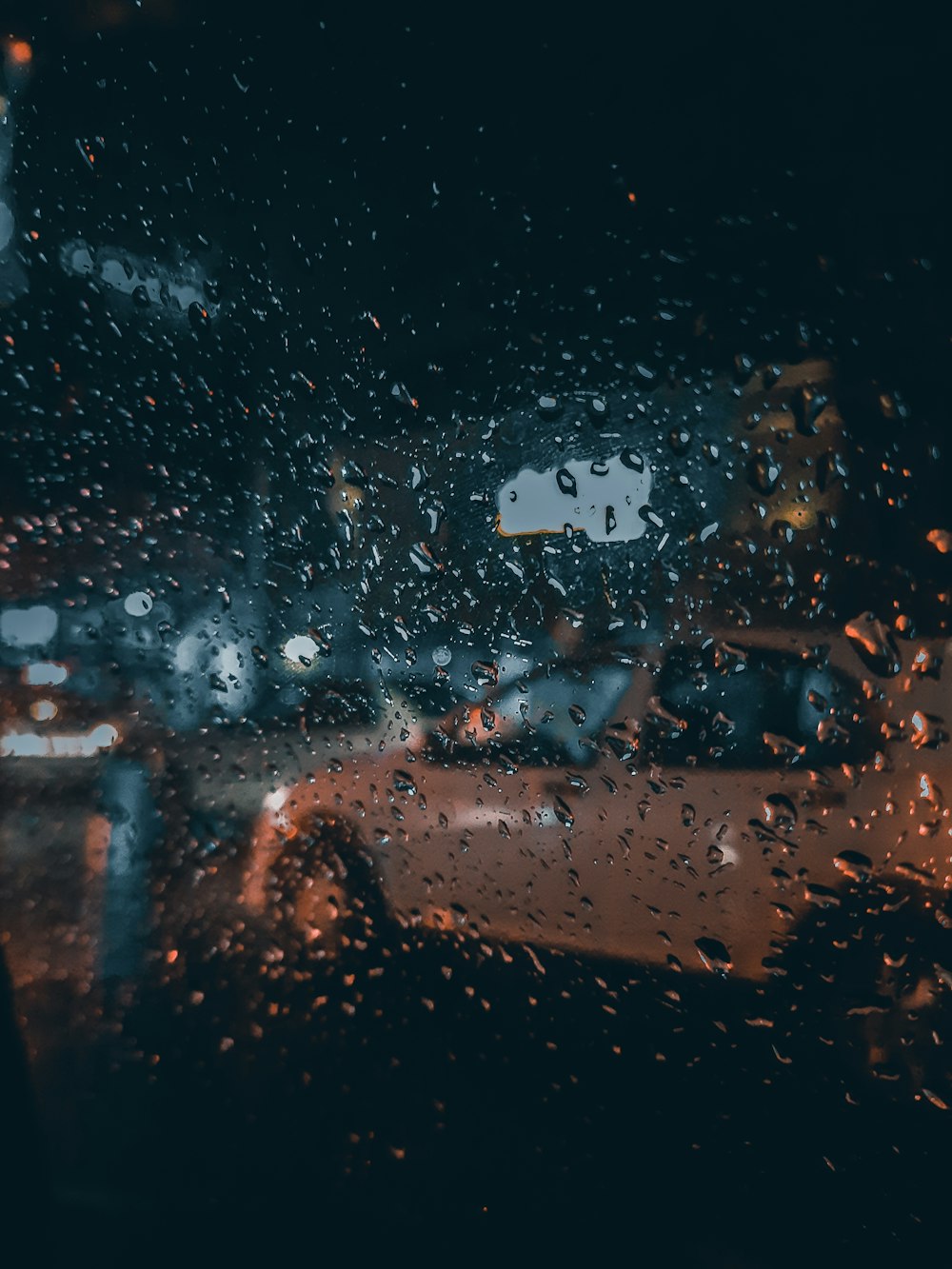 a view of a rainy street from inside a car