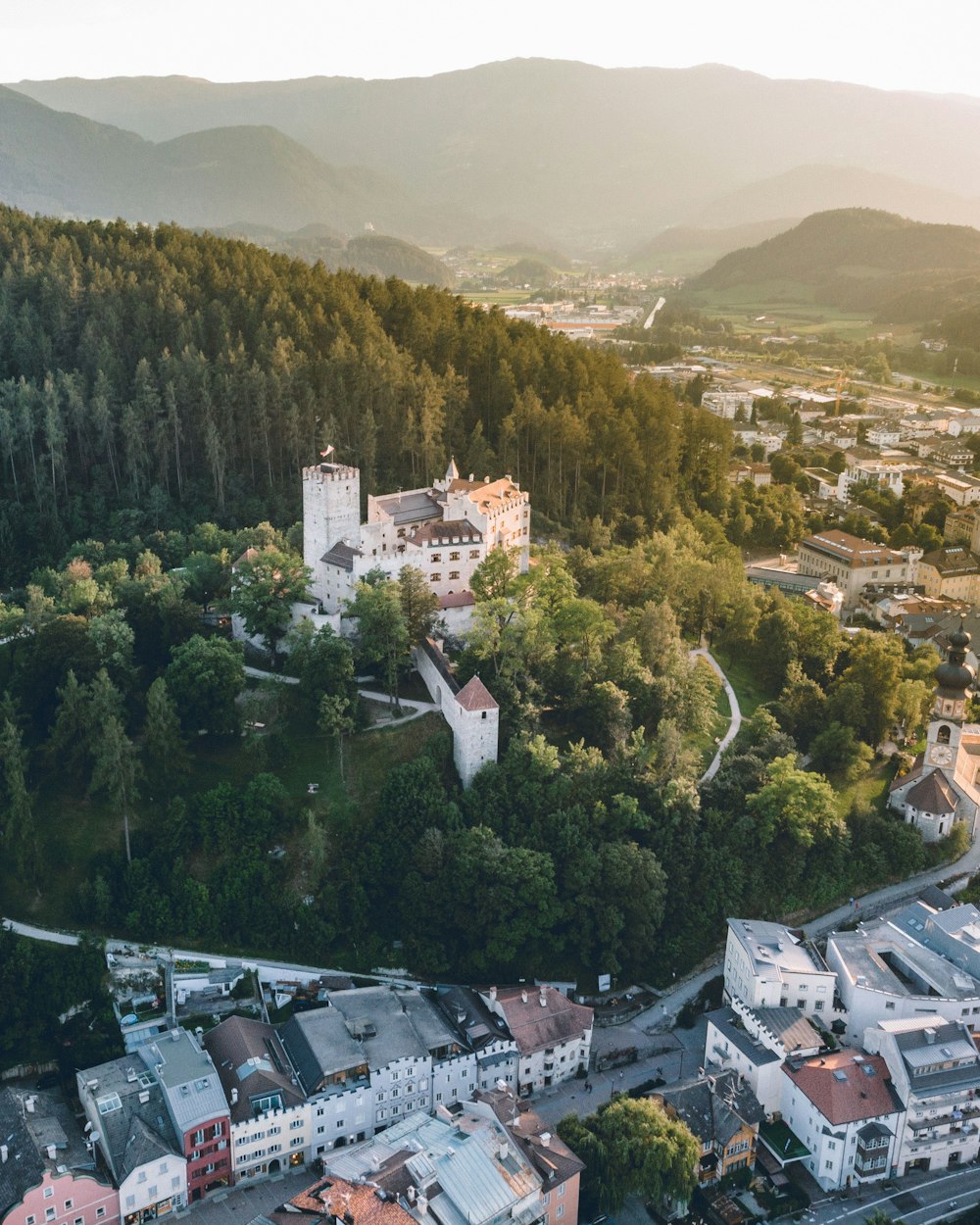 an aerial view of a town surrounded by mountains