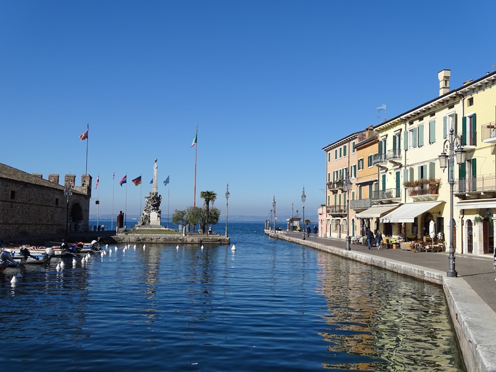 a body of water next to a row of buildings