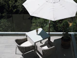 A vibrant patio cushion set arranged on a sunny balcony.
