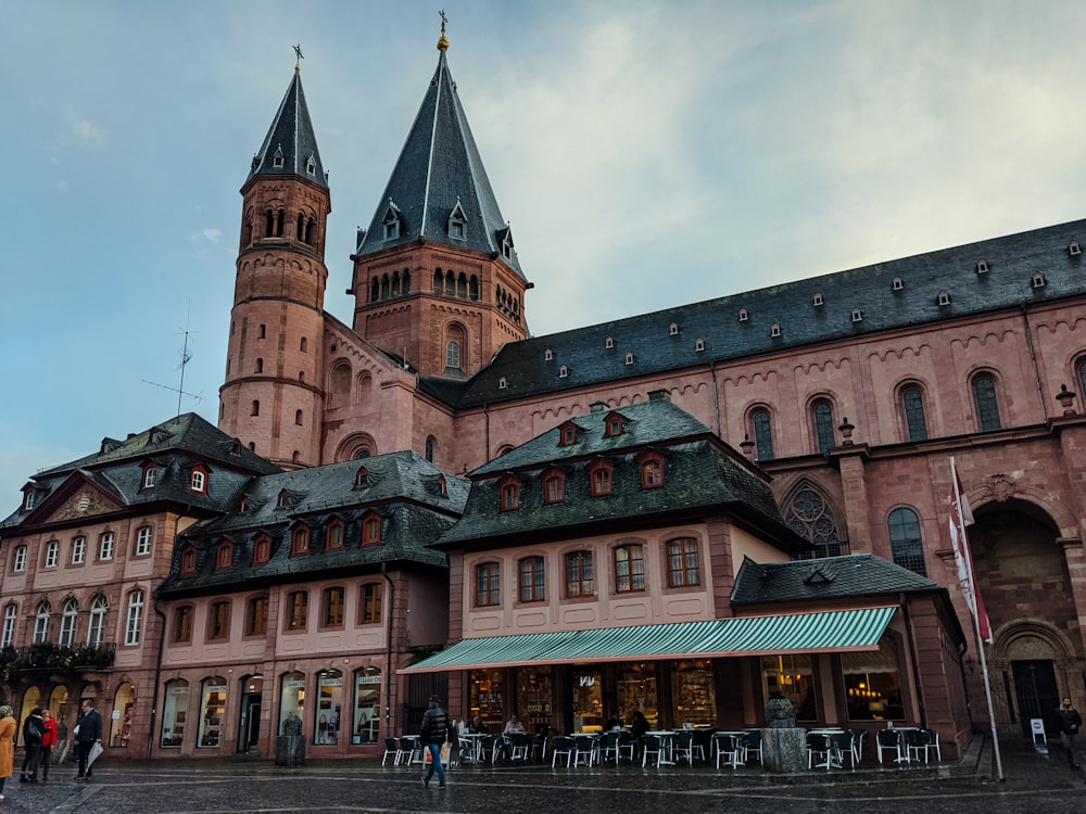 a large pink building with a clock tower