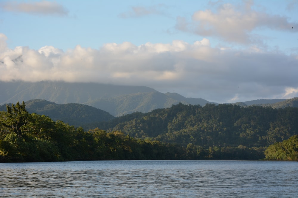 a body of water with mountains in the background