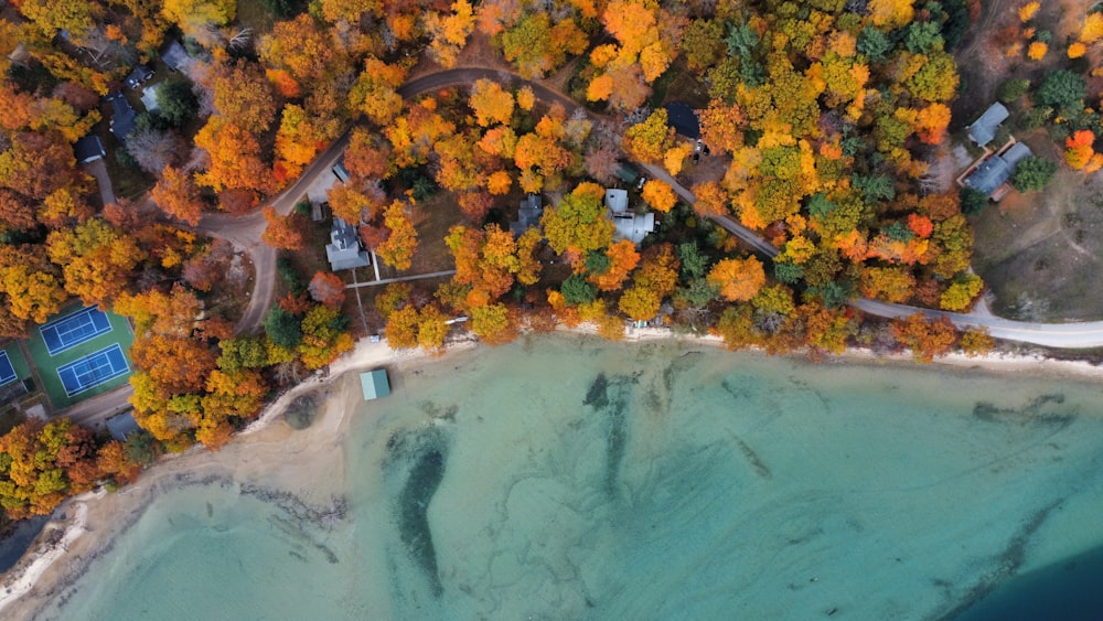 an aerial view of a tennis court surrounded by trees