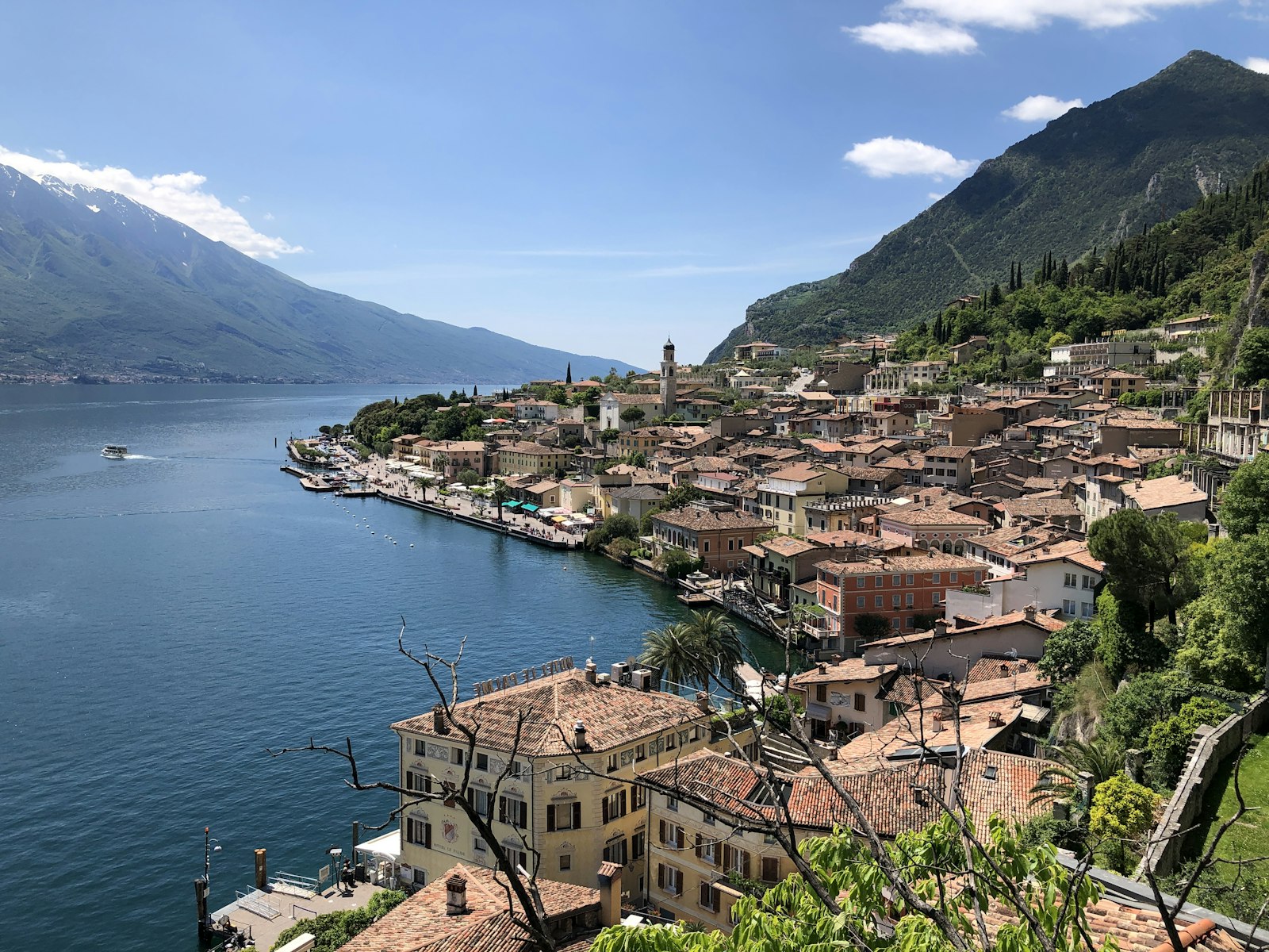 Limone sul Garda's rooftops along the shore beneath steep mountains on Lake Garda