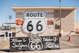 a route 66 sign in front of a building