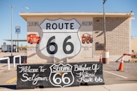a route 66 sign in front of a building