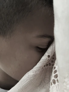 A close-up of a man peacefully sleeping wearing a sleek black silk sleep mask.