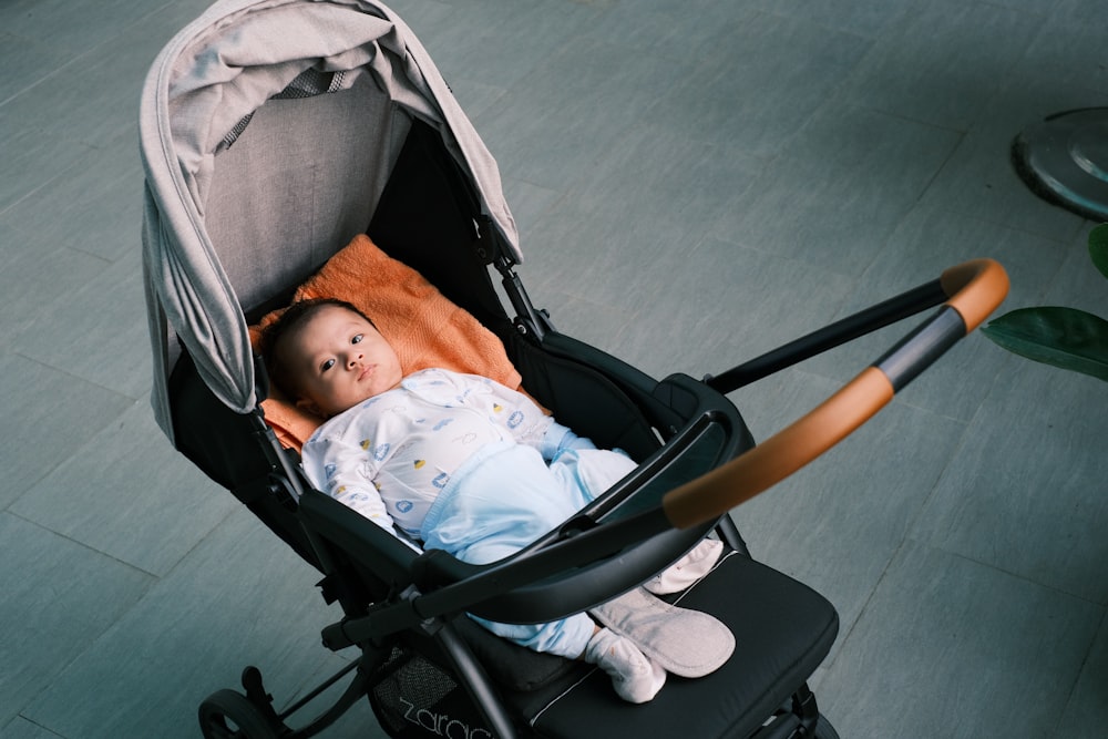 a baby is sleeping in a stroller