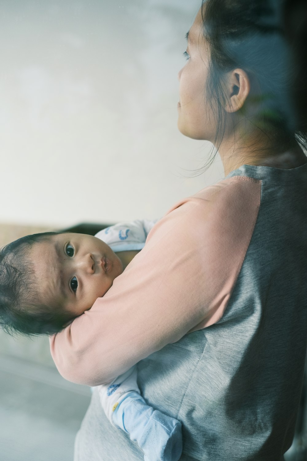 a woman holding a baby in her arms