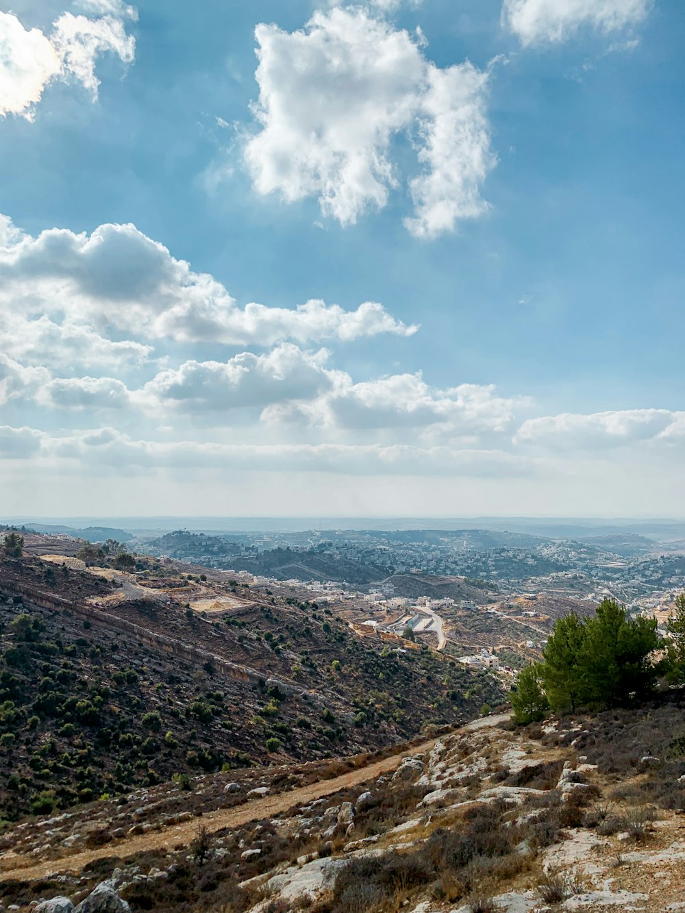 a scenic view of a valley with a sky background