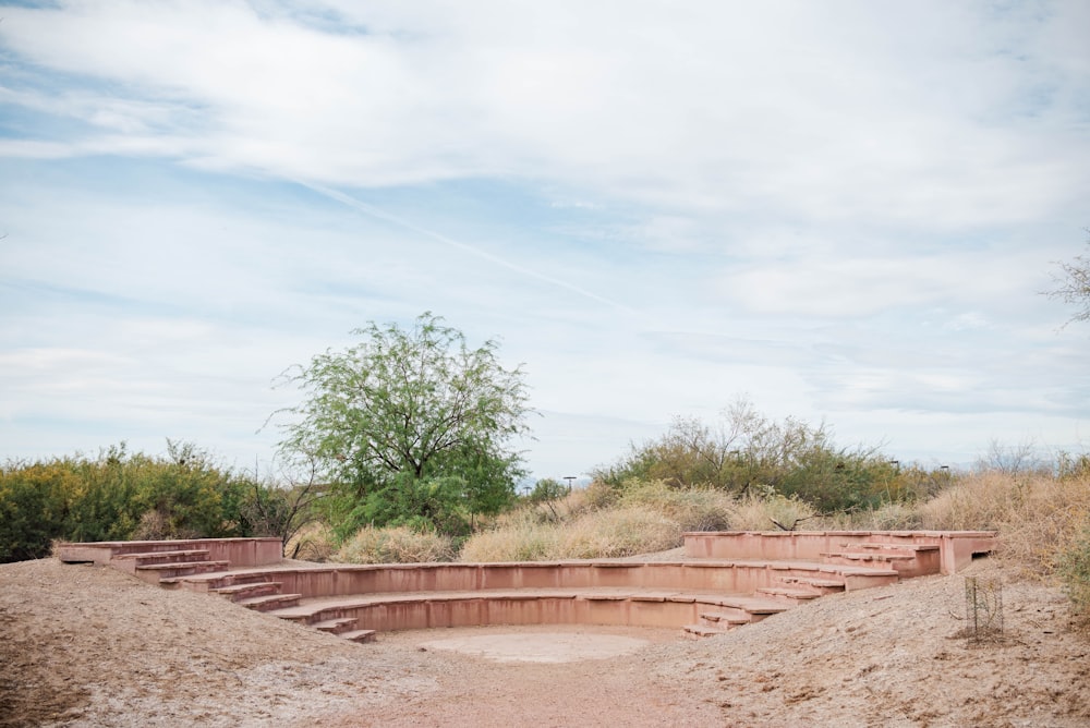 a set of steps in the middle of a dirt field