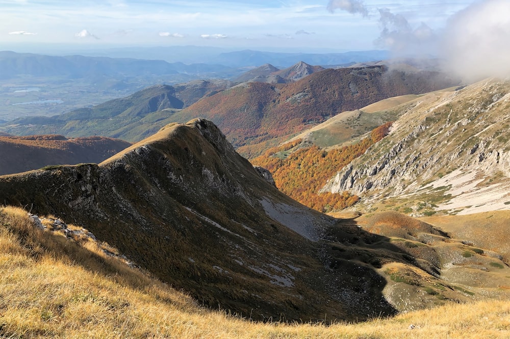 a view of a mountain range from the top of a hill