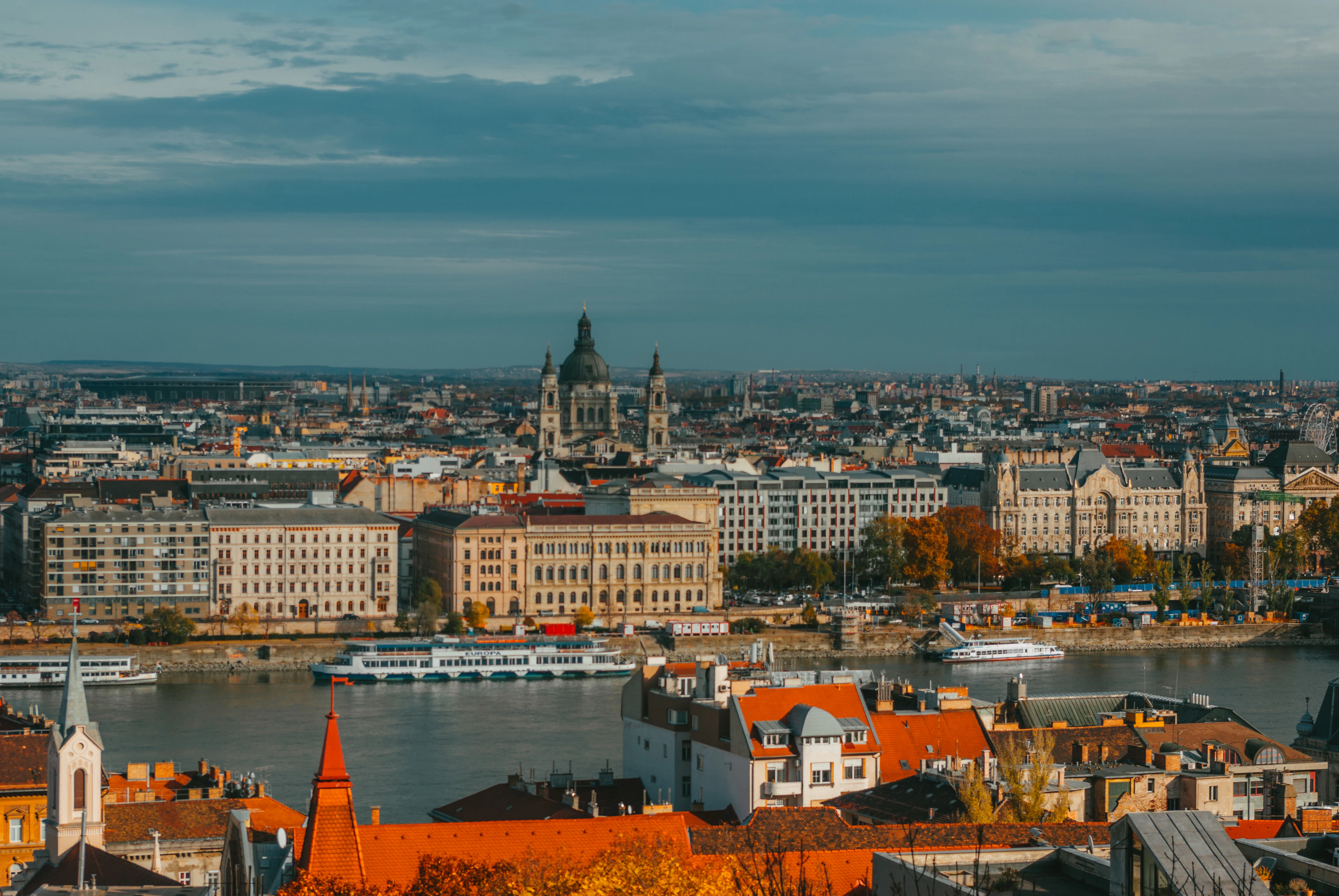 Autumn view from Fisherman's Bastion over the Danube, Pest rooftops and St. Stephen's dome.
