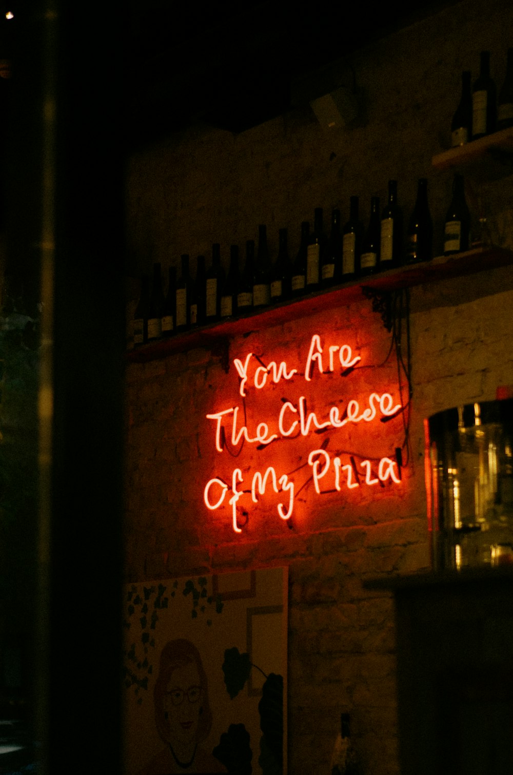 a sign on the side of a building lit up at night